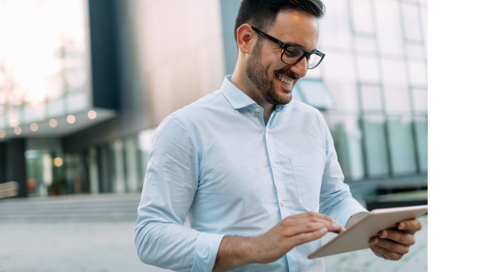 portrait-of-businessman-in-glasses-holding-tablet-AWVHCJU